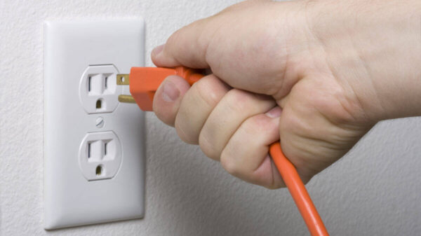 electrical cord plugs into wall socket for more energy